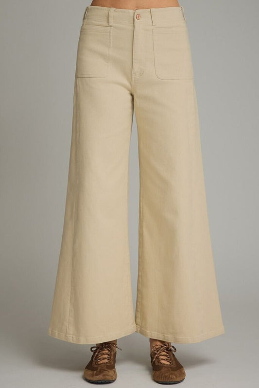 Beige wide-leg pants on a plain background