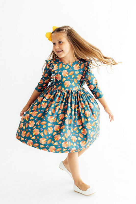 Young girl wearing a floral dress on a white background